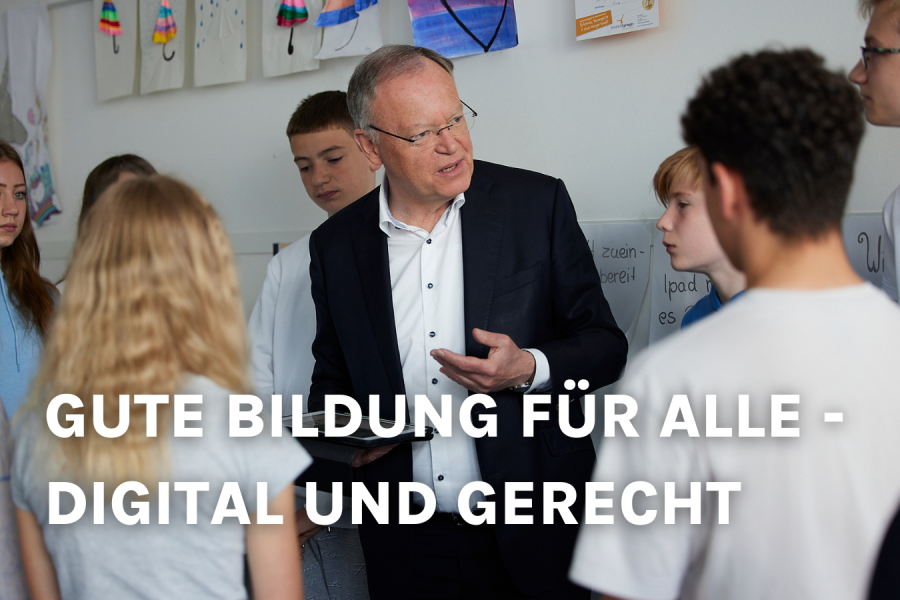 Stephan Weil mit Kindern in einer Schule